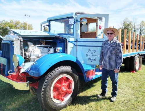 Garry Mack next to his '35 Mack Stake Truck.